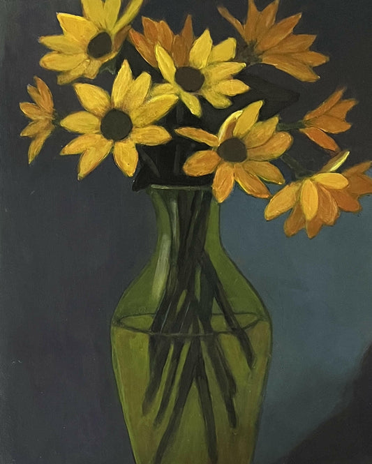 Yellow and orange flowers in green vase